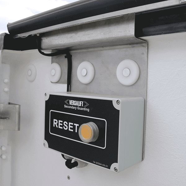 Versalift secondary guarding - reset button